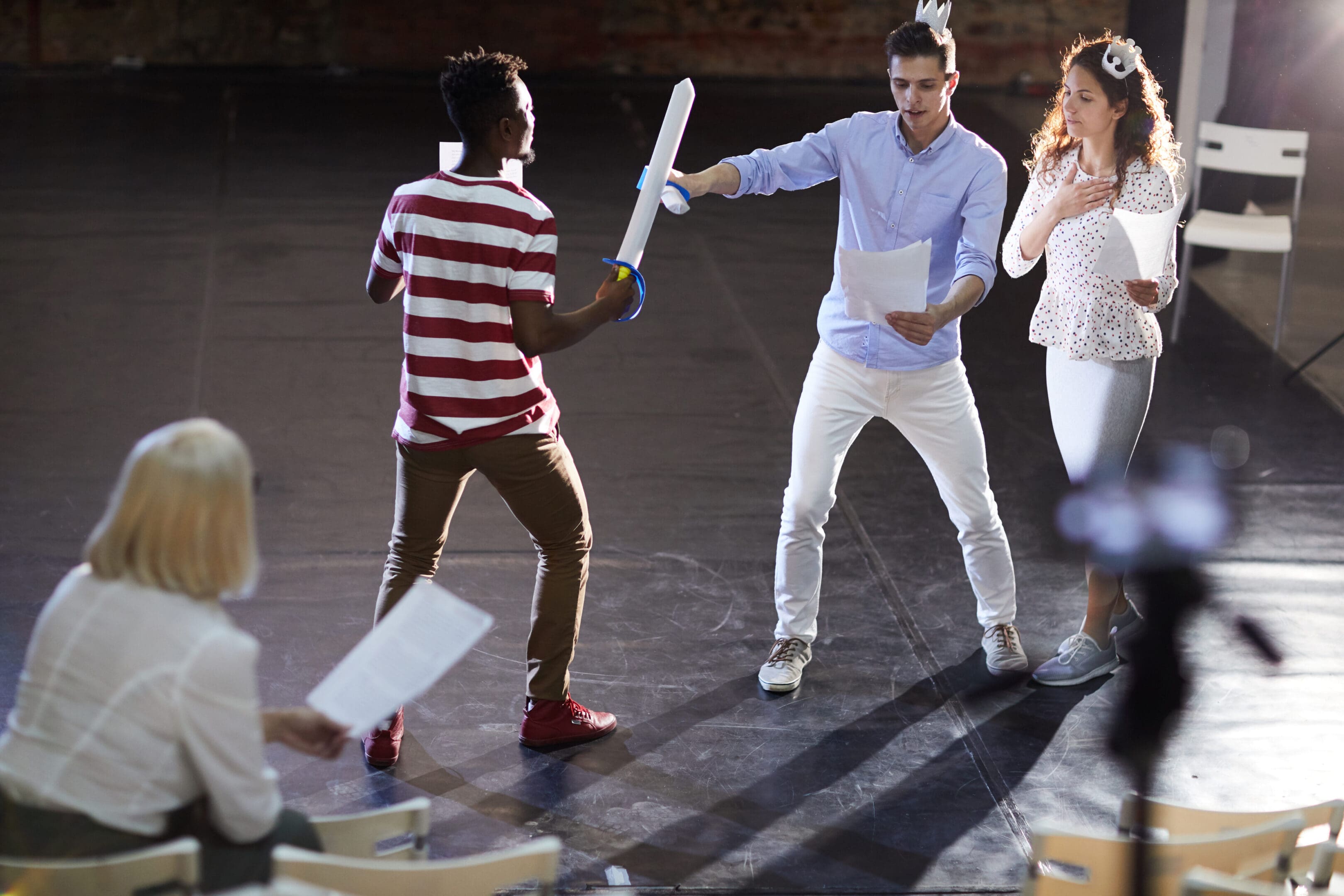 A group of people standing on the stage holding bats.