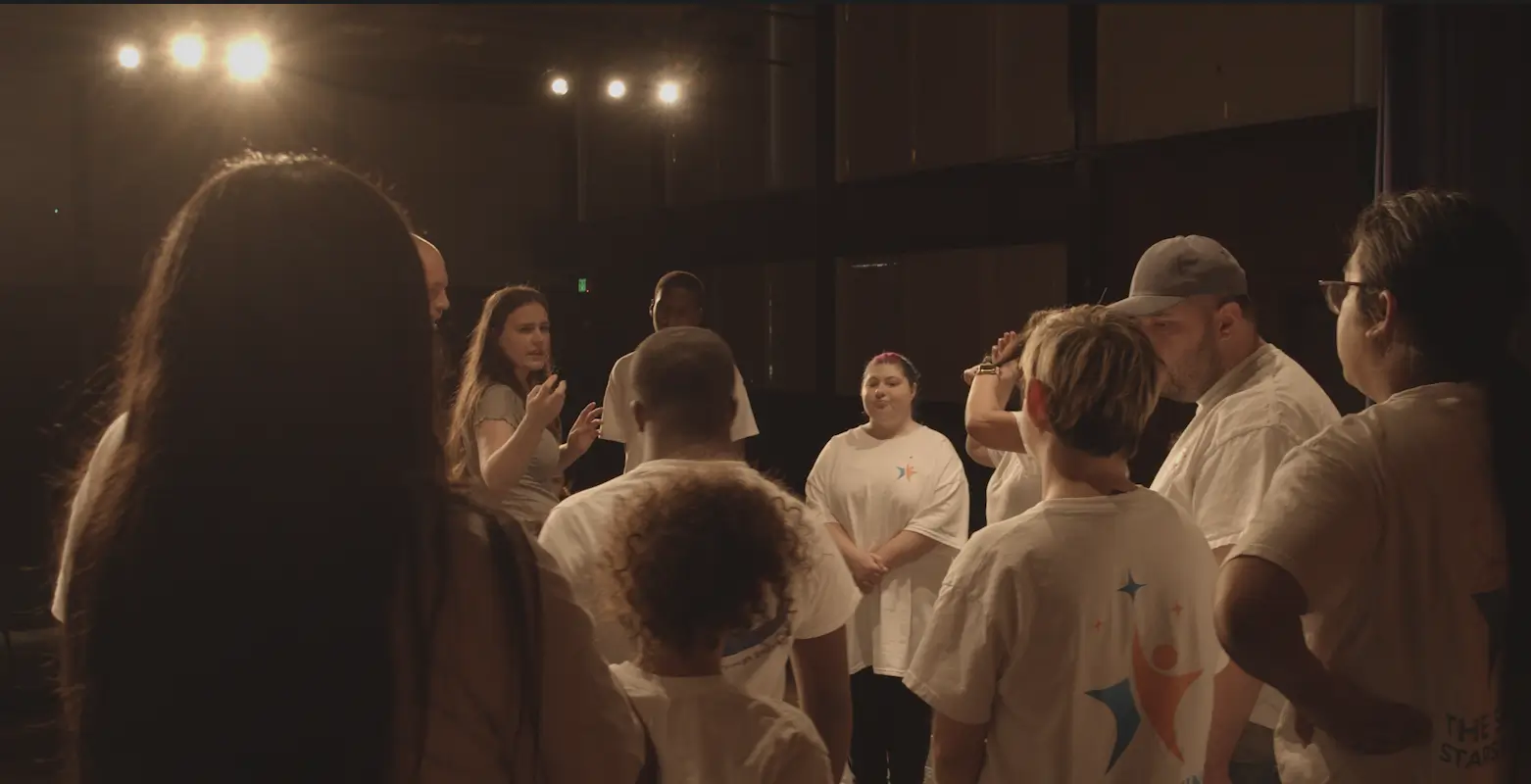 Group of people gathered on stage.